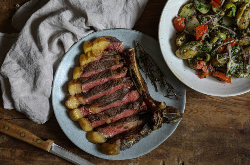Sirloin chop with a warm jersey royal, tomato and caper salad
