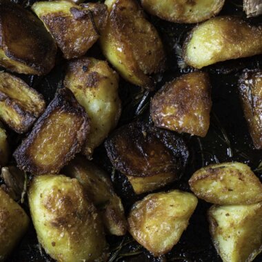 Close-up of golden, crunchy duck fat roast potatoes.