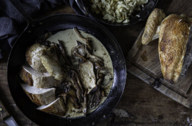 Chicken crown cooked and sliced in a pan, with wild mushrooms and cream sauce.
