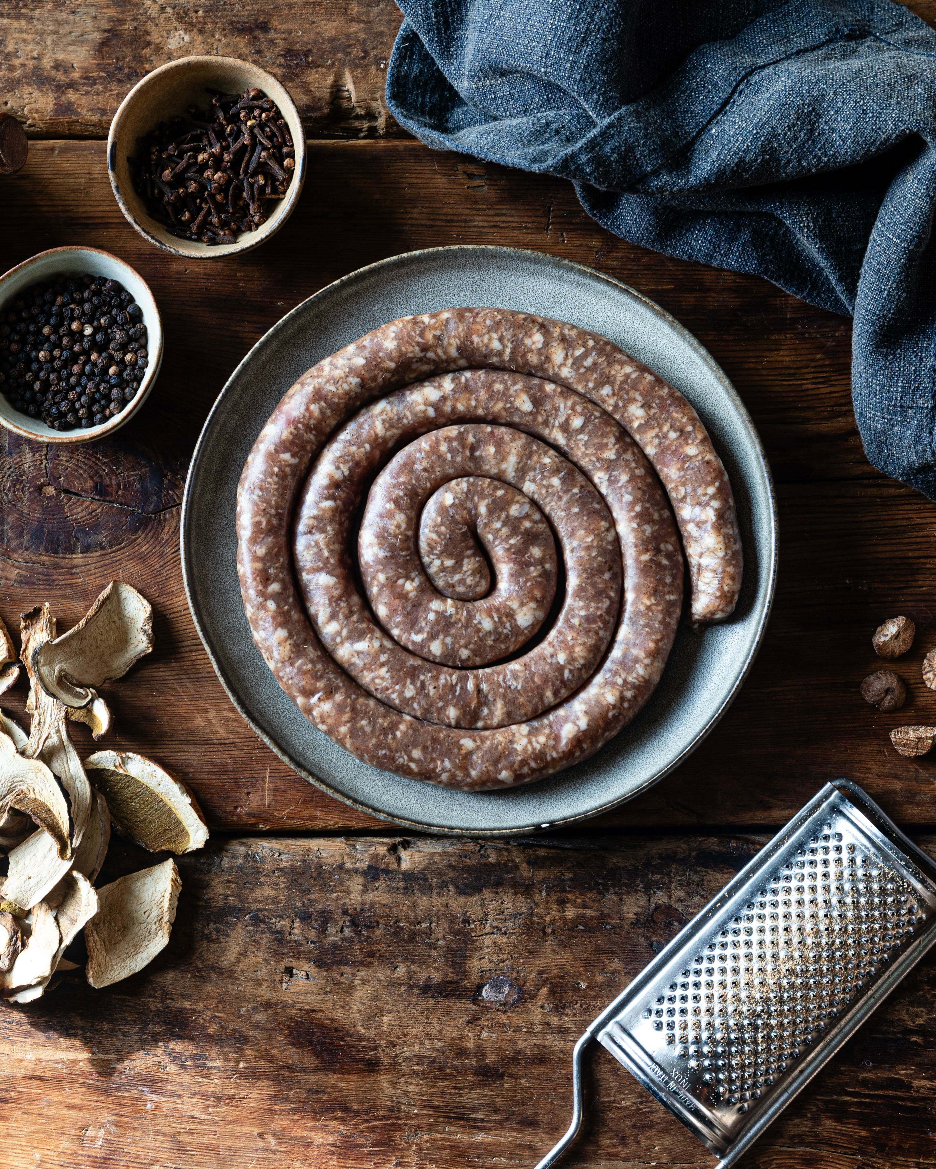 Look at this fine looking sausage. This is the fourth autumn we have made Luganega in collaboration with @jacobkenedy Kenedy of @bocca_di_lupo , and it has become one of the small rituals of our year.

We make it with shoulder and belly from our native breed pigs, seasoned with dried porcini, black pepper, nutmeg, cinnamon and a little clove, before coiling it into its spiral. The spice is gentle and the porcini gives it a deep, earthy savour that suits the turn of the season.

In Soho, Jacob serves it with farro, roasted porcini and tarragon. We tend to cook ours more plainly, in a hot pan with polenta or lentils and some bitter leaves on the side, which is no worse for it.
