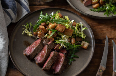 Sharing rump steak cooked medium-rare with beef fat croutons and frisée salad.