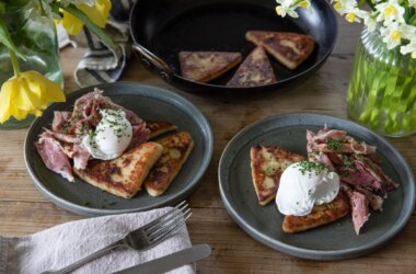 Two plates of potato scones topped with flaked ham hock and a poached egg.