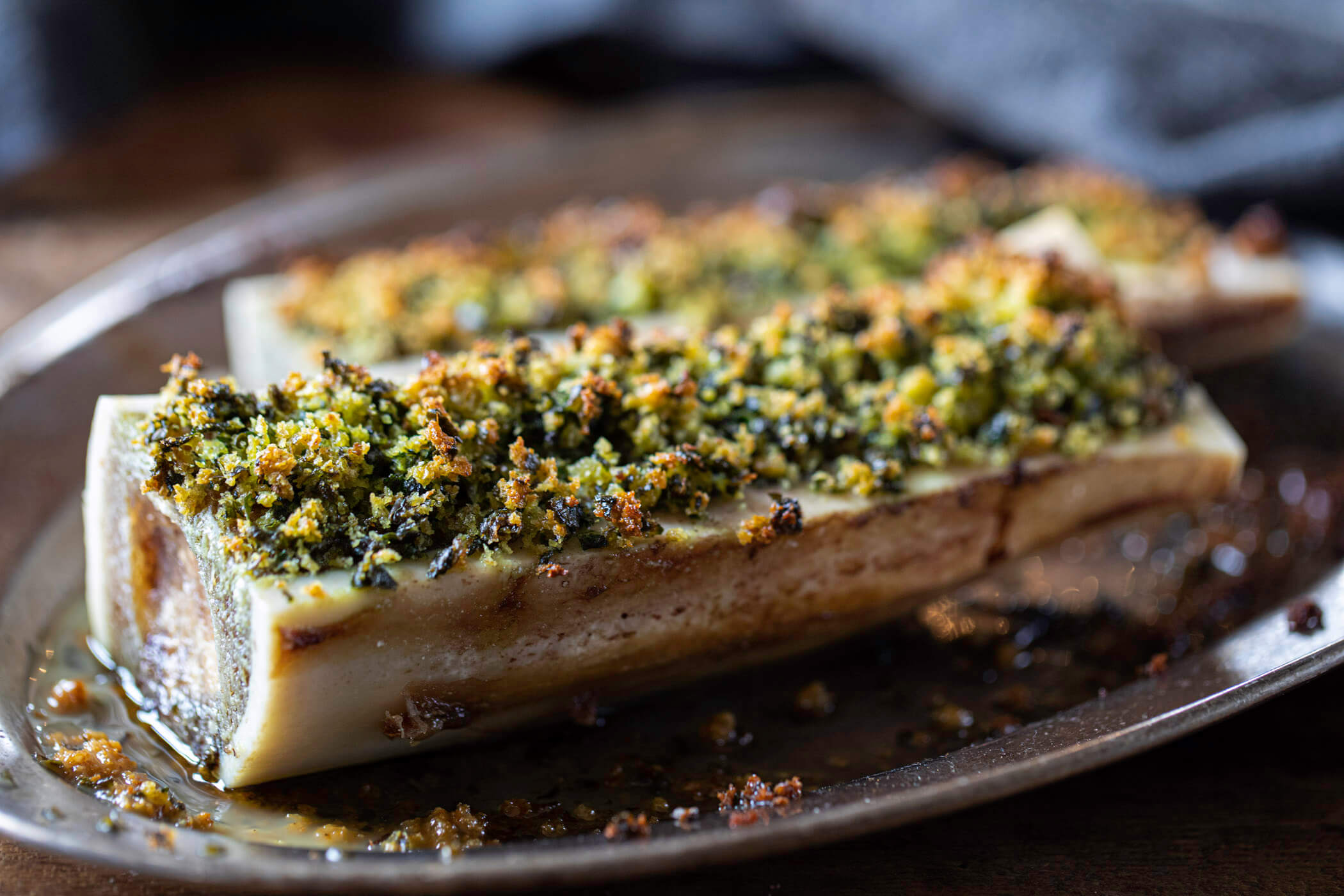 Close-up of bone marrow canoes with a garlic and parsley crumb.