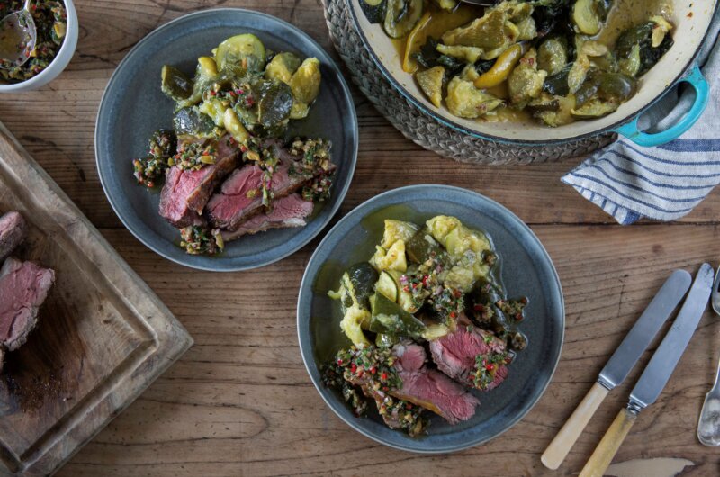 Hogget rump cooked pink, served alongside braised courgettes and a green olive dressing.