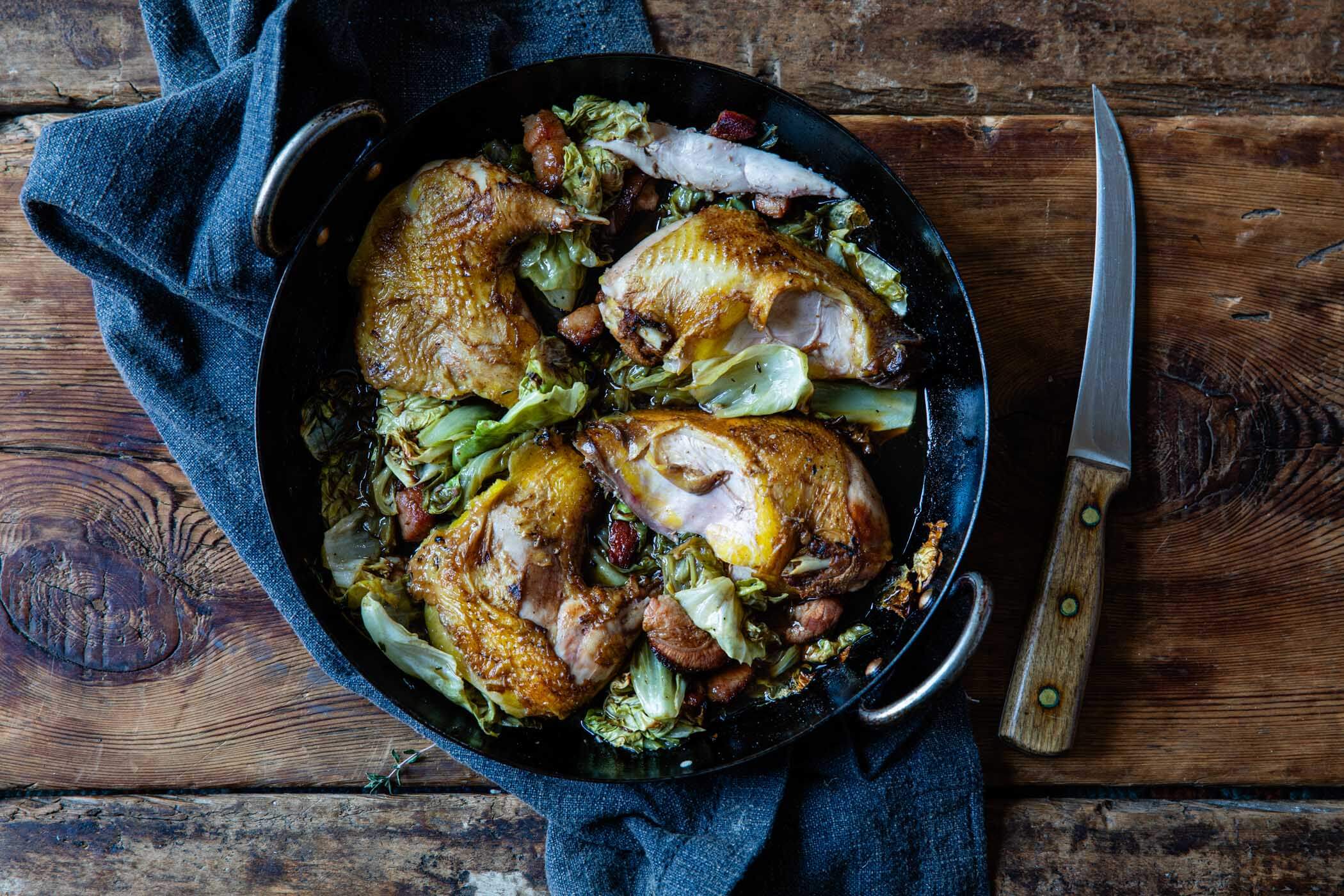 Plated whole pheasant roasted with cabbage bacon and marsala.