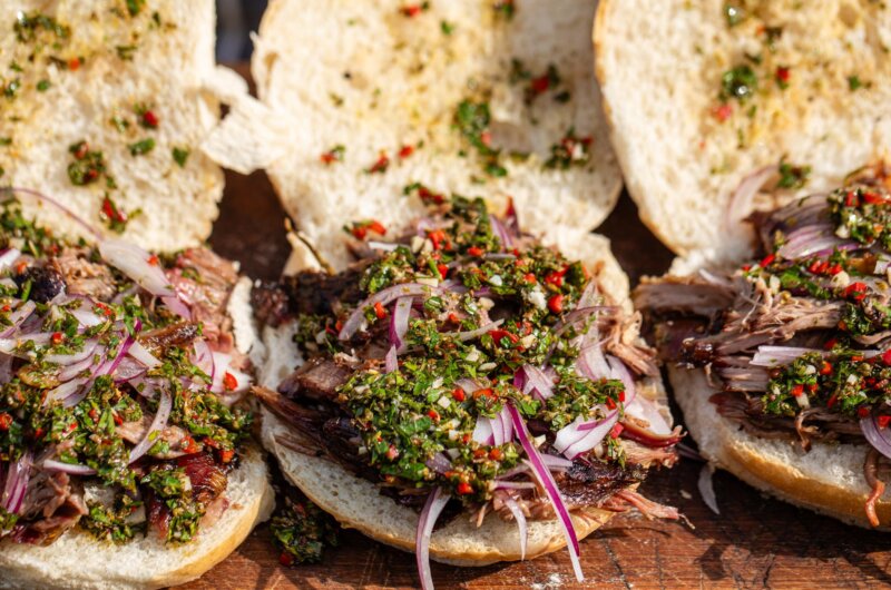 Smoked hogget shoulder piled into soft buns, topped with vibrant green chimichurri sauce