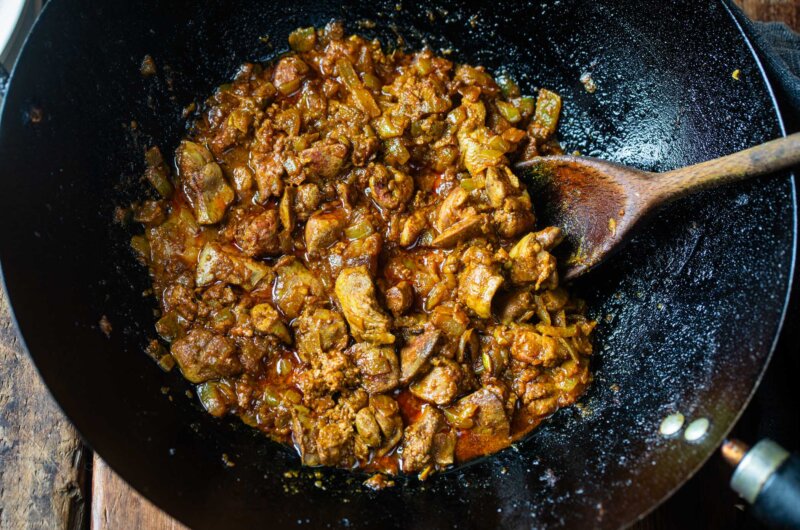 Spicy Burmese chicken liver stir-fry cooked in a wok with chillies, garlic, and spices