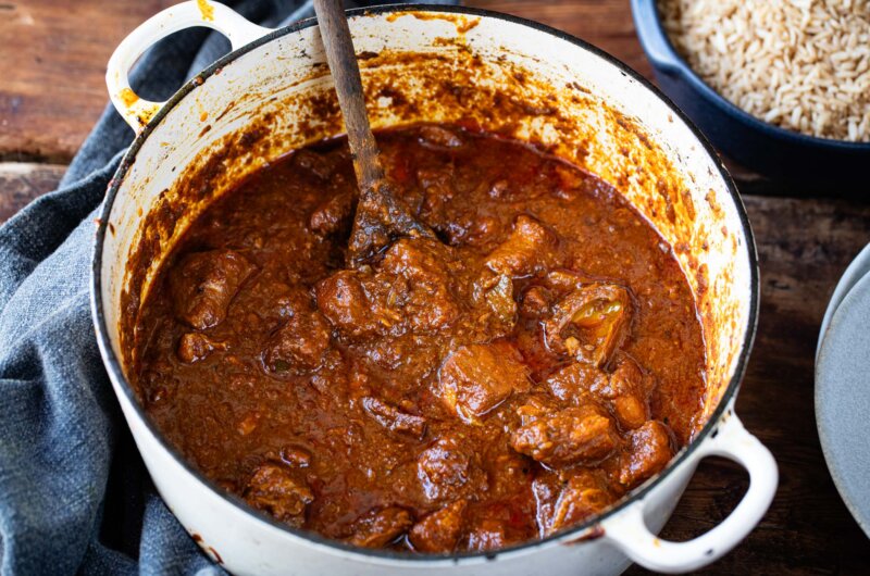 Rich Burmese pork and mango pickle curry cooked in a casserole dish, a vibrant and flavourful family recipe from The Rangoon Sisters