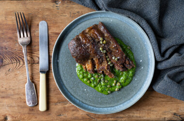 Crisp lamb breast served on a bed of mint and coriander sauce, garnished with baby capers and thinly sliced salad onion