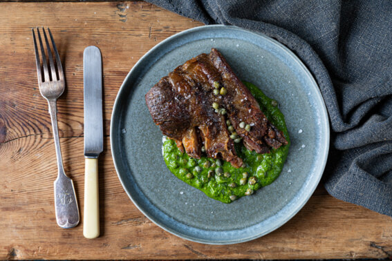 Crisp lamb breast served on a bed of mint and coriander sauce, garnished with baby capers and thinly sliced salad onion