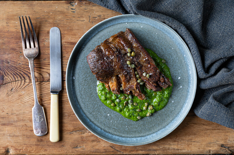 Crisp lamb breast served on a bed of mint and coriander sauce, garnished with baby capers and thinly sliced salad onion