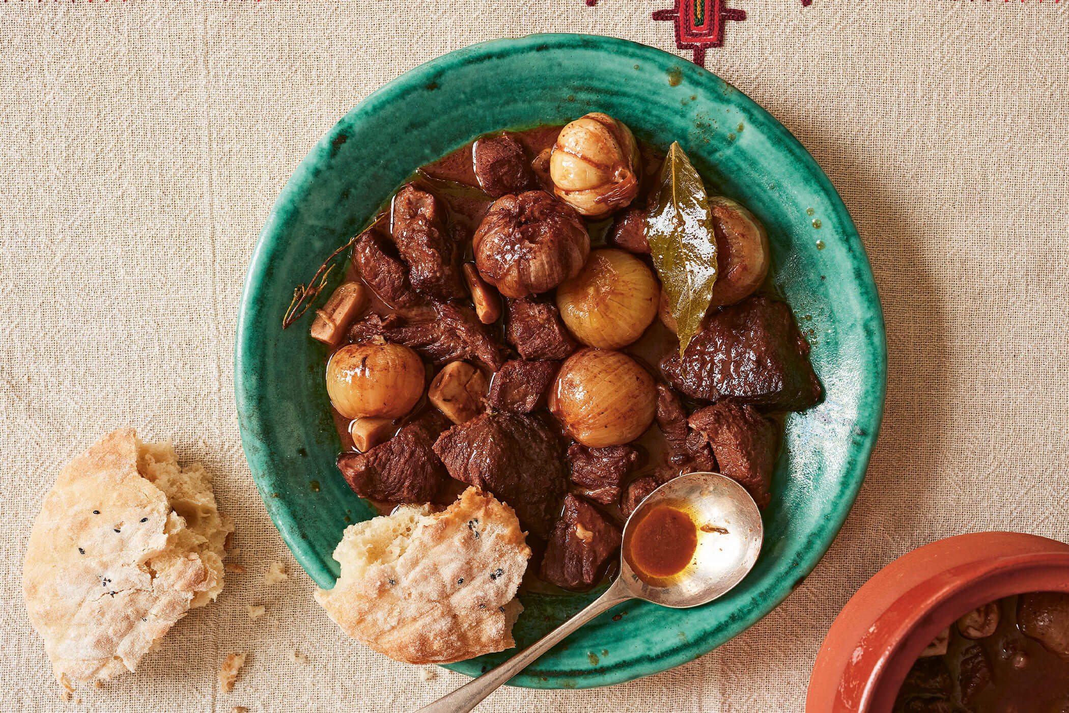 Traditional Ohrid-style beef stew with shallots and garlic, slow-cooked until tender and served in an earthenware pot