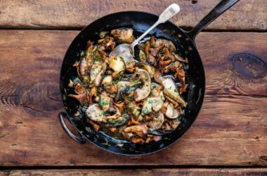 Golden girolles and ceps sautéed in a cast-iron skillet with butter, garlic and parsley