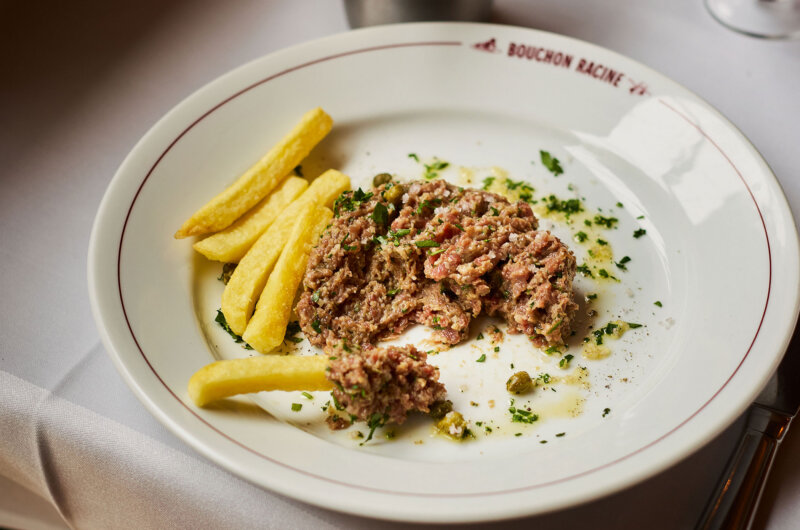 Steak tartare served with frites on a white plate