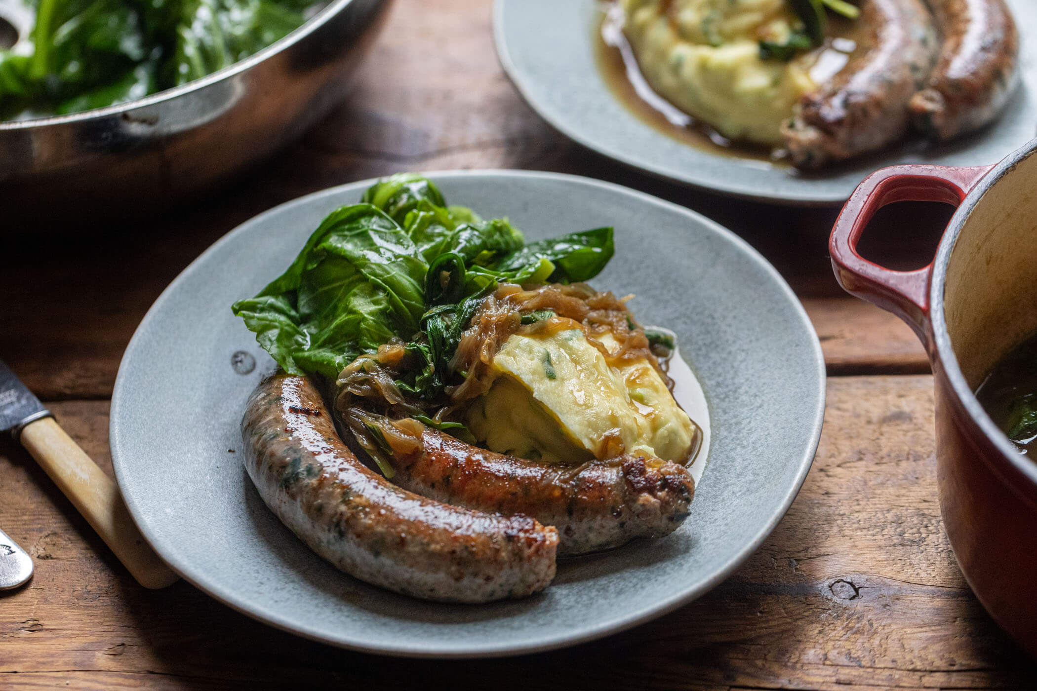Wild Garlic Sausages with Champ Mash, Spring Greens & Onion Gravy